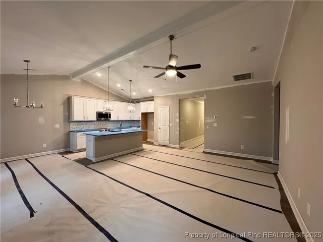 a kitchen with sink a stove and cabinets