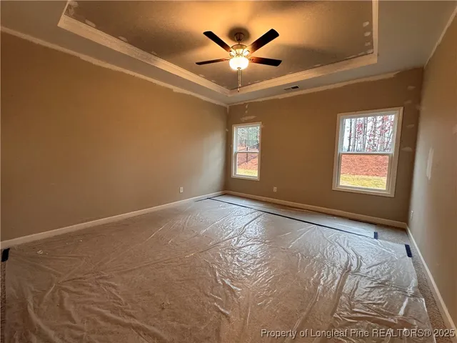 a view of a livingroom with a ceiling fan and window