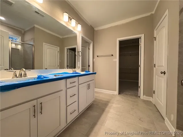 a bathroom with a glass shower door