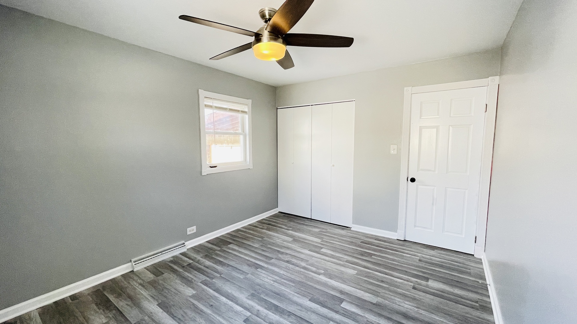 Undisclosed Address Addison, IL 60101 - Photo 11 of 26 wooden floor in an empty room with a window