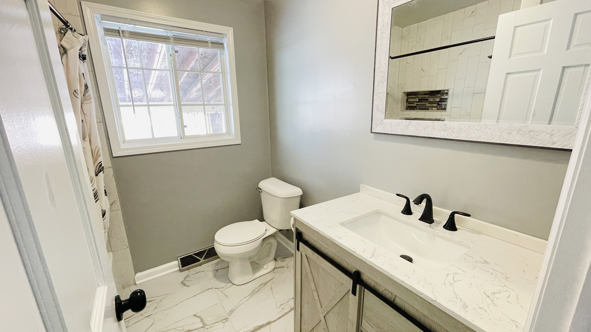 Undisclosed Address Addison, IL 60101 - Photo 17 of 26 a bathroom with a sink a toilet and a window