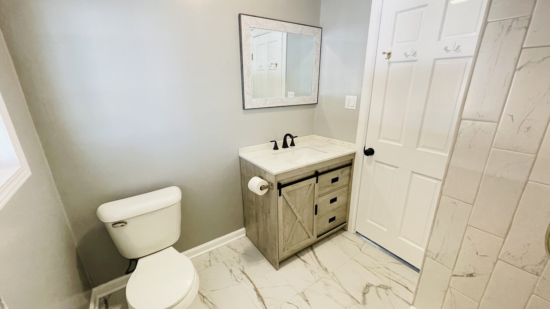 Undisclosed Address Addison, IL 60101 - Photo 18 of 26 a bathroom with a toilet a sink and mirror