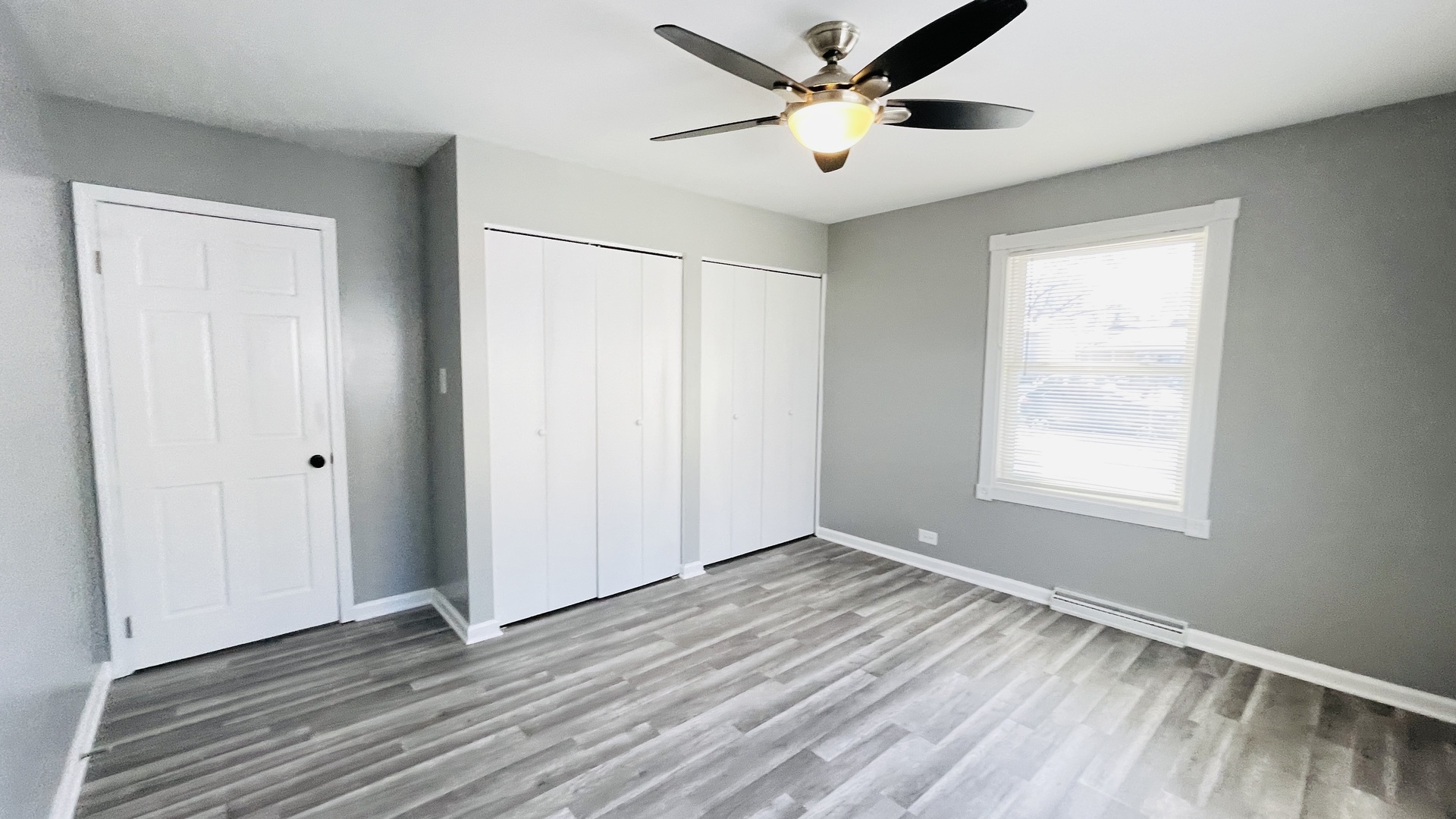 Undisclosed Address Addison, IL 60101 - Photo 9 of 26 a view of an empty room with window and wooden floor