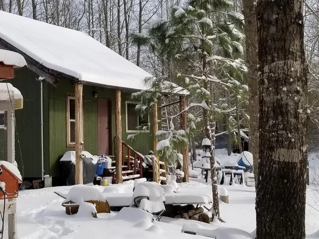 a room with furniture a chandelier and a flat screen tv