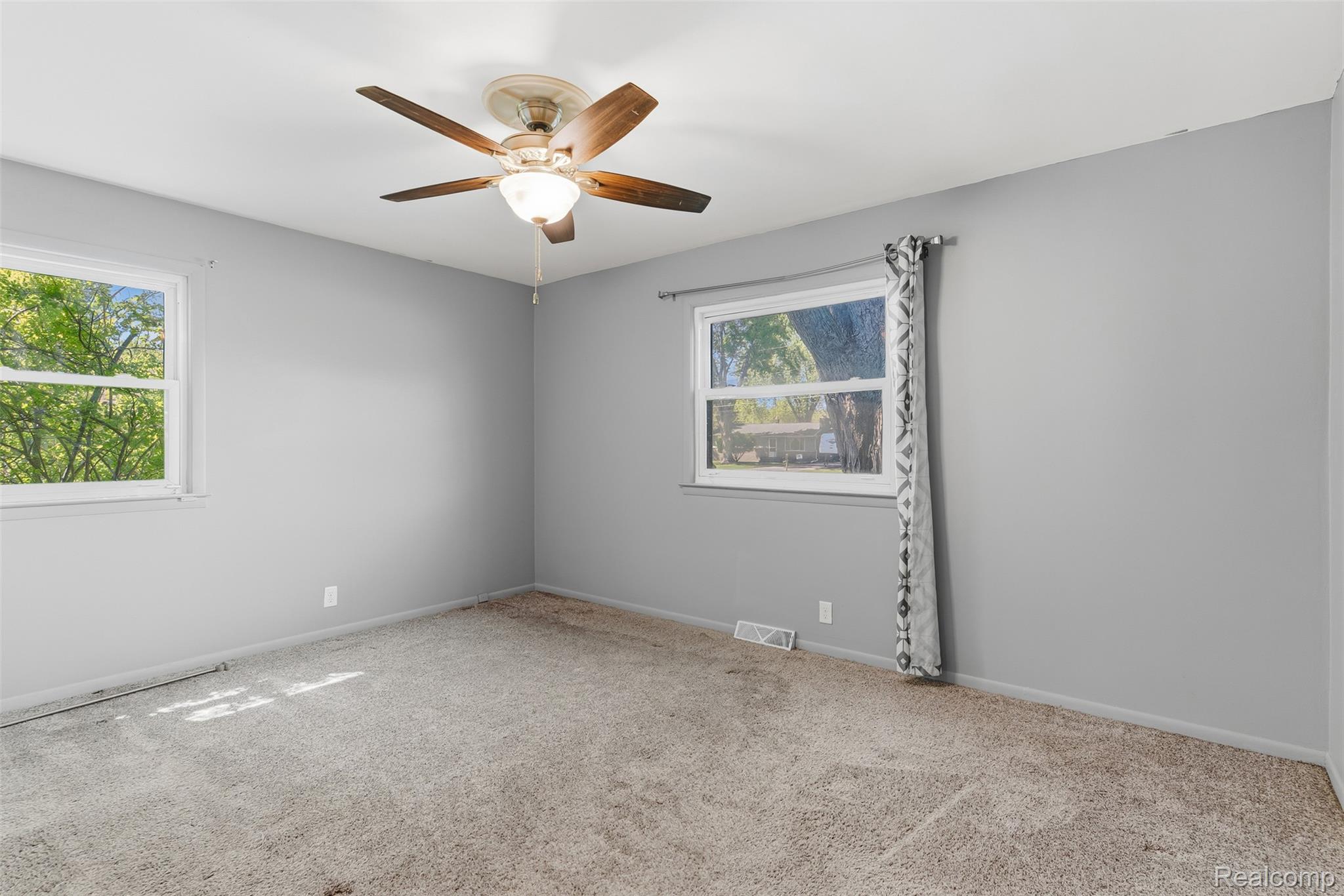 7230 North Center Road Mount Morris, MI 48458 - Photo 18 of 33 Carpeted empty room featuring baseboards and ceiling fan