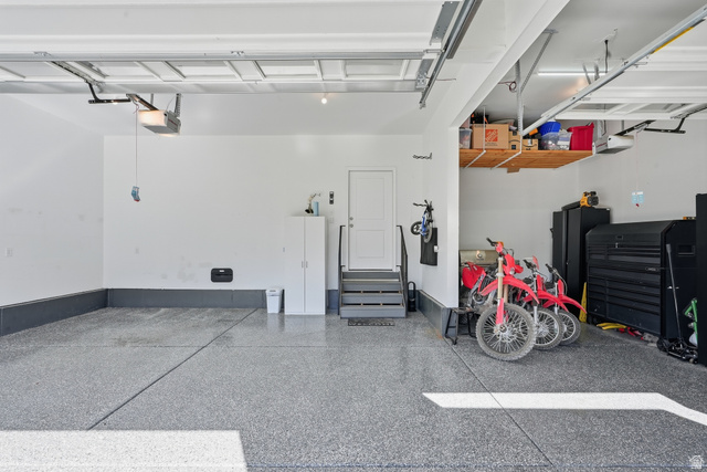 1202 South Raintree Lane Santaquin, UT 84655 - Photo 42 of 45 Spacious garage featuring a durable epoxy floor, integrated overhead storage, and an interior access door