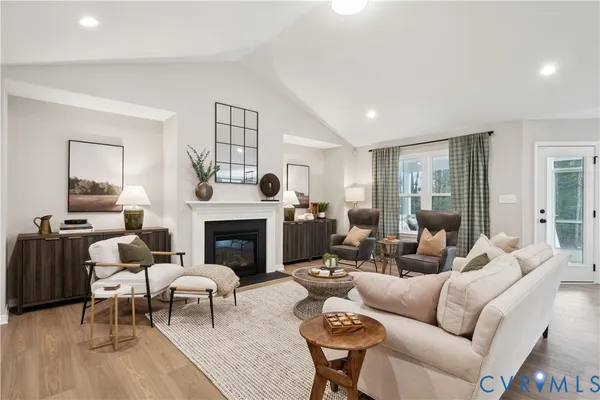 a living room with furniture fireplace and window