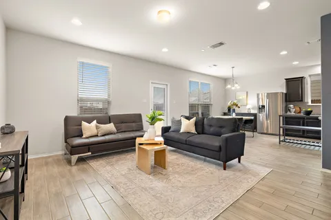 a living room with furniture and wooden floor