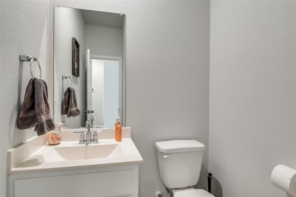 8413 Alba Lane Rowlett, TX 75089 - Photo 13 of 25 a bathroom with a toilet sink and mirror