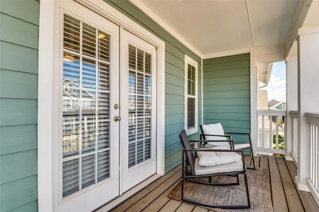 a view of a porch with wooden floor and roof deck