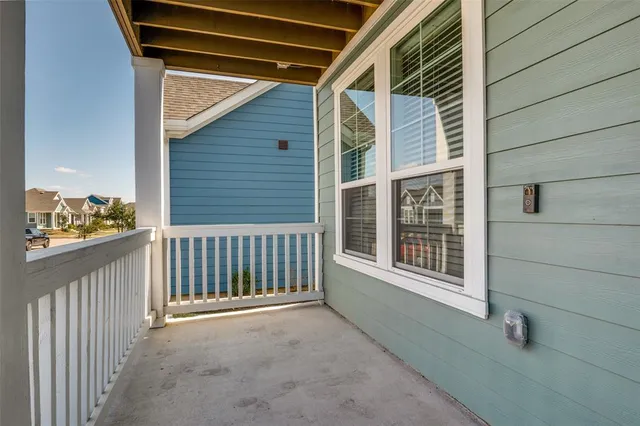 a view of a house with a patio and wooden fence