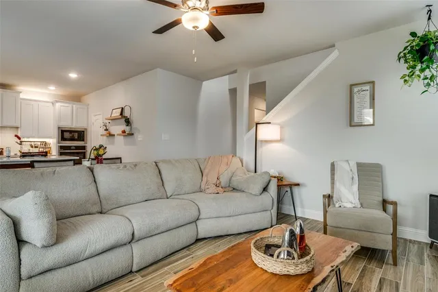 a living room with furniture and a chandelier