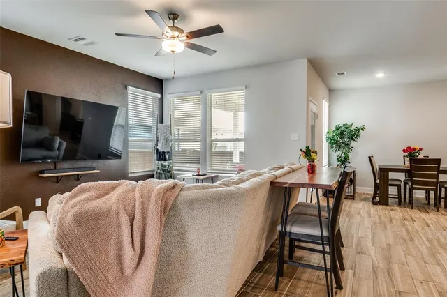 a living room with fireplace furniture and a flat screen tv