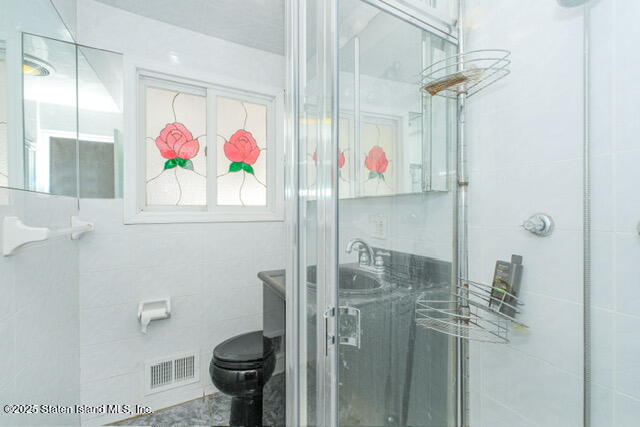 25 Berry Avenue West Staten Island, NY 10312 - Photo 11 of 24 a bathroom with a sink a toilet and shower