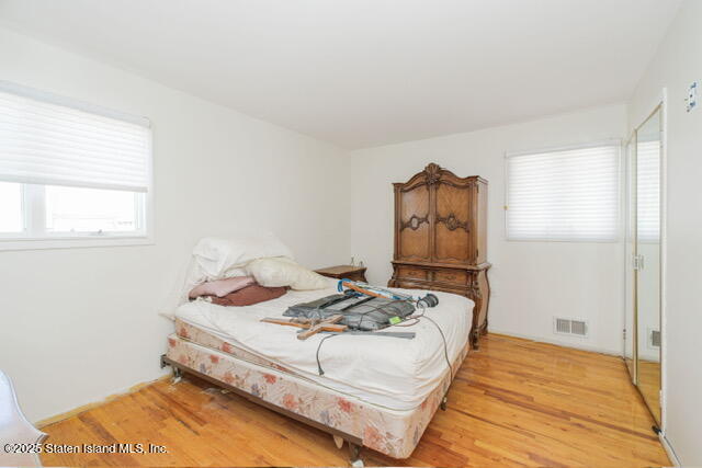 25 Berry Avenue West Staten Island, NY 10312 - Photo 16 of 24 a bed sitting in a bedroom next to a window