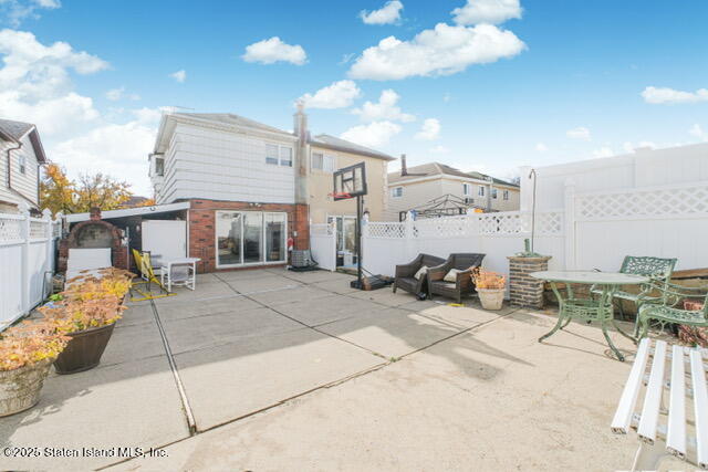 25 Berry Avenue West Staten Island, NY 10312 - Photo 23 of 24 a view of a patio with dining table and chairs with wooden floor