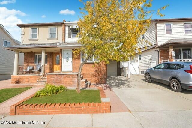 25 Berry Avenue West Staten Island, NY 10312 - Photo 3 of 24 a front view of a house with a yard and garage