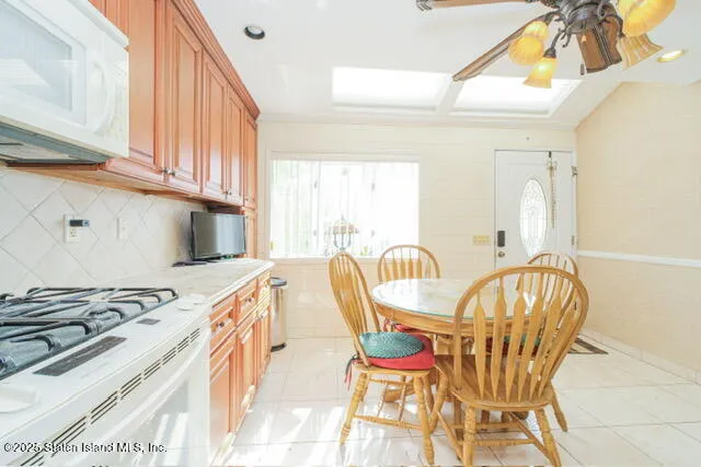 a dining room with furniture and a window