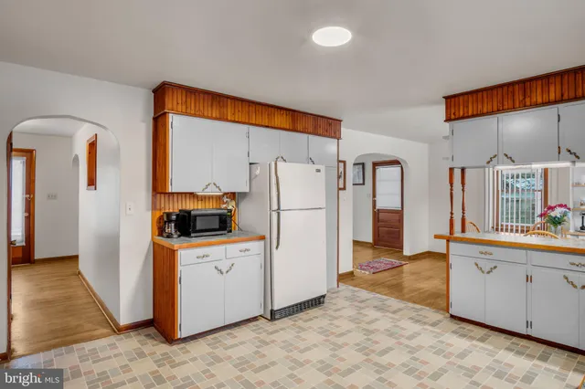a kitchen with stainless steel appliances a sink and cabinets
