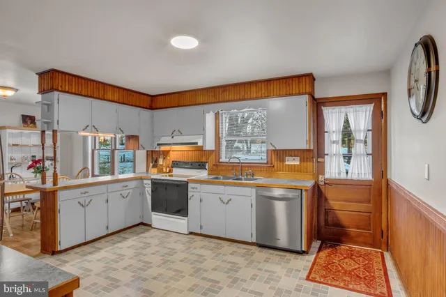 a view of a room with wooden floor lounge chair and windows