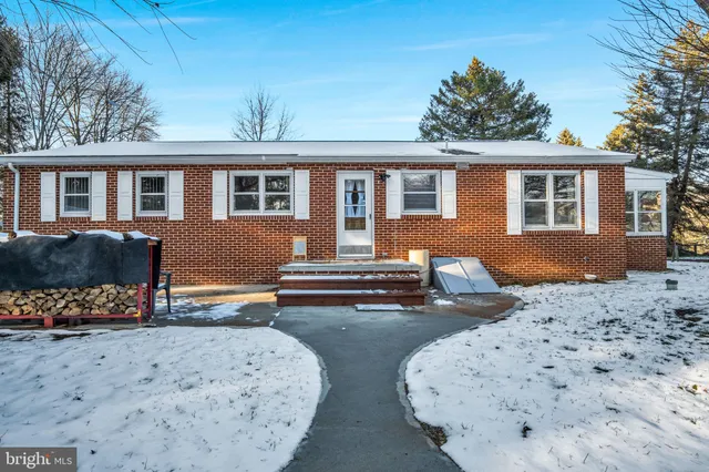 a house that has a tree in front of it