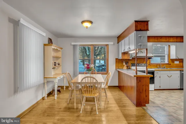 a dining room with furniture and flowers
