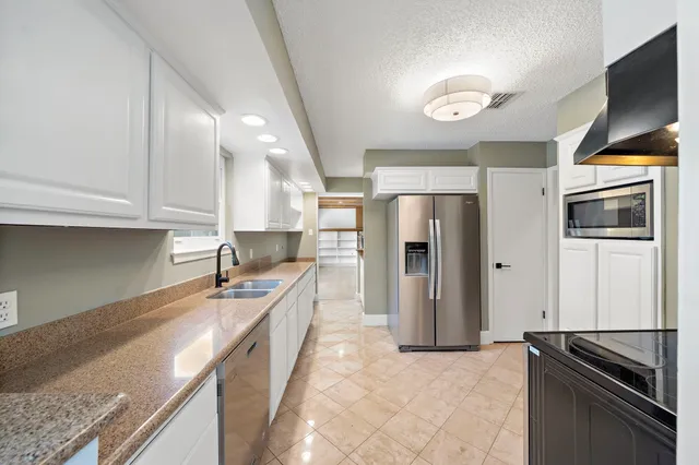 a view of kitchen and hall with wooden floor