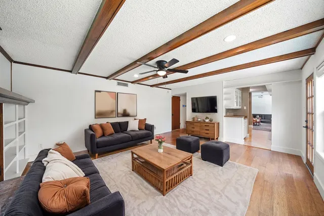 a view of empty room with wooden floor and fireplace