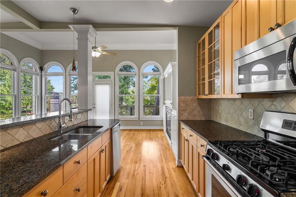 911 Monroe Circle Northeast Atlanta, GA 30308 - Photo 14 of 86 a kitchen with lots of counter top space and wooden floor