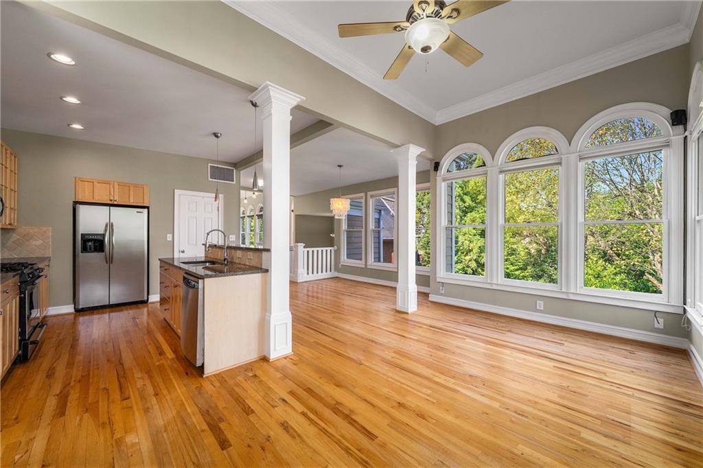 911 Monroe Circle Northeast Atlanta, GA 30308 - Photo 16 of 86 a view of a kitchen with furniture a kitchen wooden floor and stainless steel appliances
