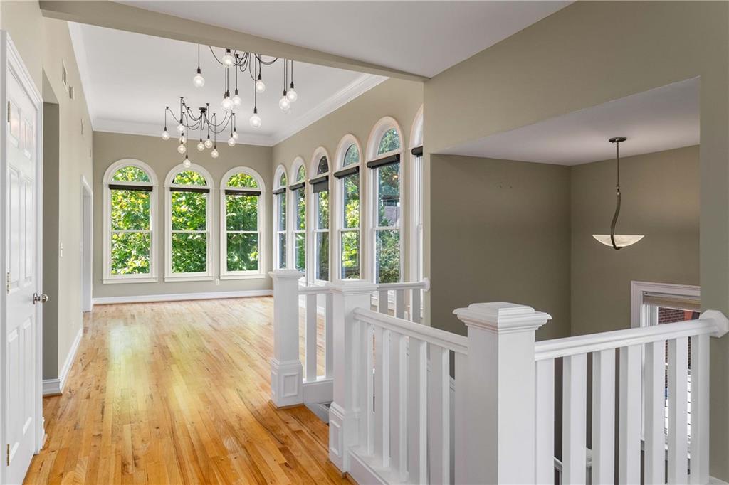 911 Monroe Circle Northeast Atlanta, GA 30308 - Photo 18 of 86 a view of a bedroom with wooden floor and windows