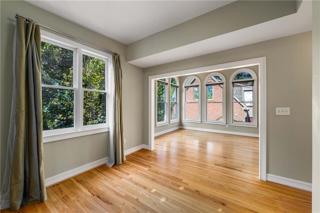 911 Monroe Circle Northeast Atlanta, GA 30308 - Photo 20 of 86 a view of an empty room with wooden floor and a window