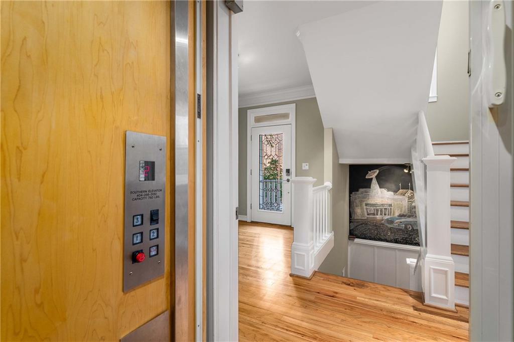 911 Monroe Circle Northeast Atlanta, GA 30308 - Photo 22 of 86 a view of a hallway with wooden floor and living room