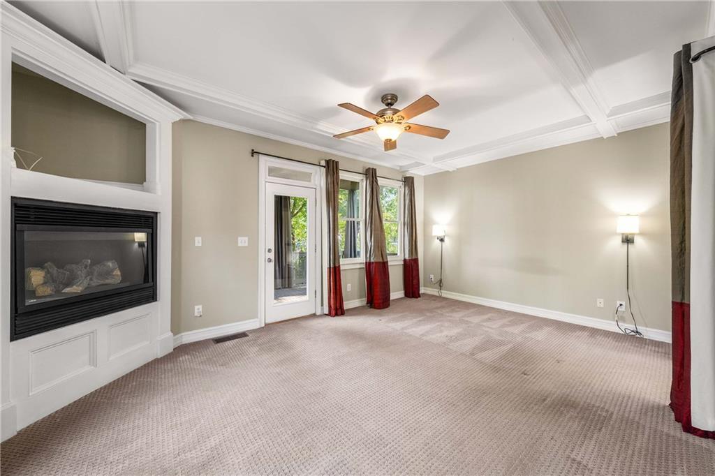911 Monroe Circle Northeast Atlanta, GA 30308 - Photo 24 of 86 a view of a livingroom with a fireplace a ceiling fan and window