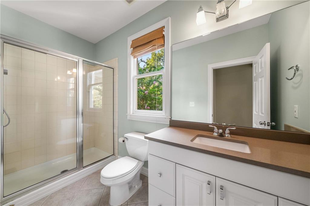 911 Monroe Circle Northeast Atlanta, GA 30308 - Photo 31 of 86 a bathroom with a granite countertop sink toilet and shower