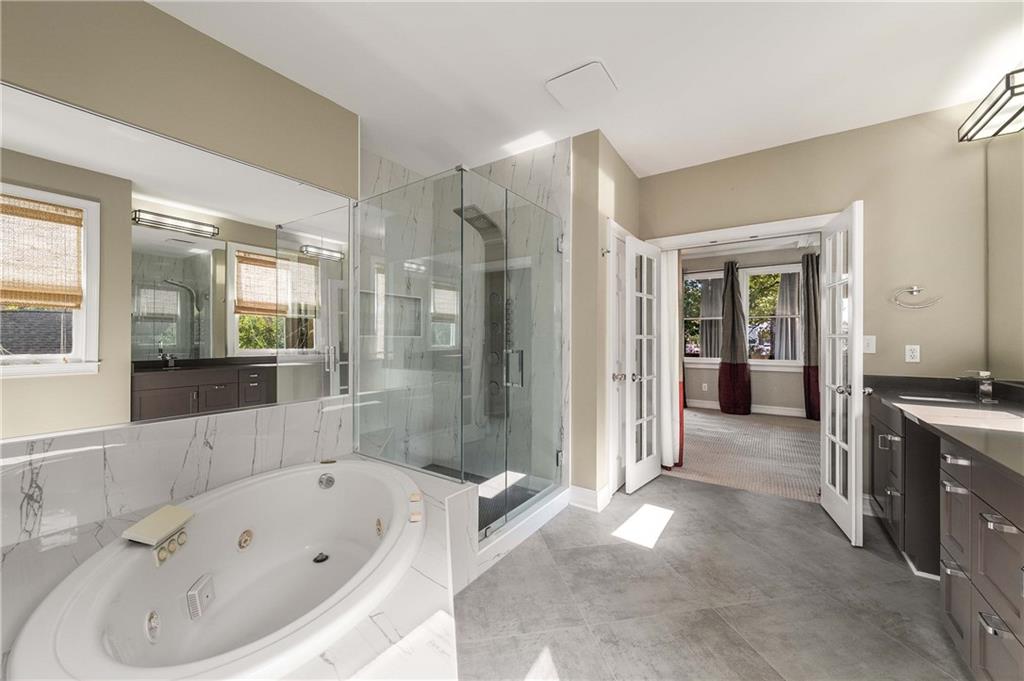 911 Monroe Circle Northeast Atlanta, GA 30308 - Photo 38 of 86 a bathroom with a bathtub and a shower