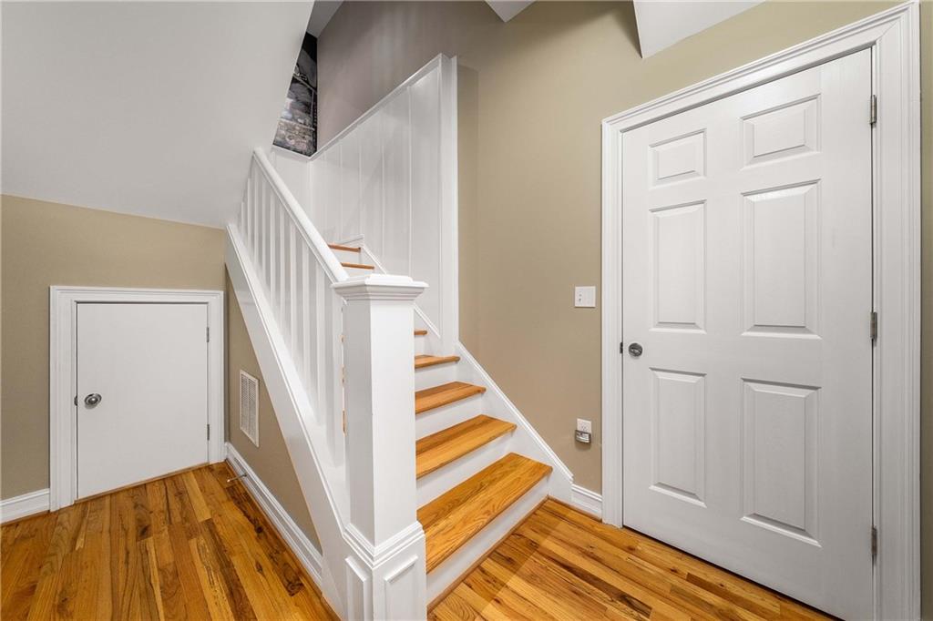 911 Monroe Circle Northeast Atlanta, GA 30308 - Photo 39 of 86 a view of a hallway with wooden floor and staircase