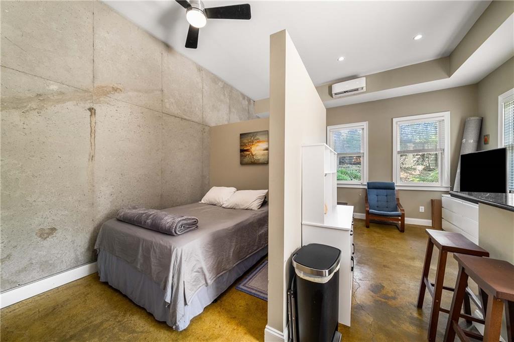 911 Monroe Circle Northeast Atlanta, GA 30308 - Photo 44 of 86 a spacious bedroom with a bed and a flat screen tv