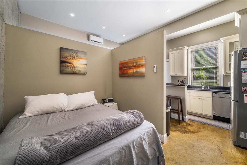 911 Monroe Circle Northeast Atlanta, GA 30308 - Photo 45 of 86 a bedroom with a bed and a view of kitchen