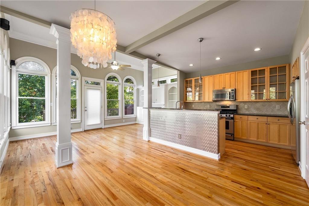 911 Monroe Circle Northeast Atlanta, GA 30308 - Photo 10 of 86 a view of a living room kitchen with wooden floor and chandelier