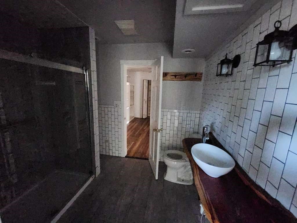 108 East 9th Street Channing, TX 79018 - Photo 11 of 16 a bathroom with a toilet and a shower