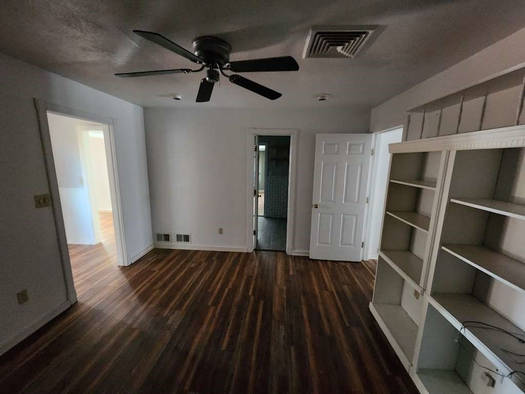 108 East 9th Street Channing, TX 79018 - Photo 12 of 16 a view of an empty room with wooden floor and a window