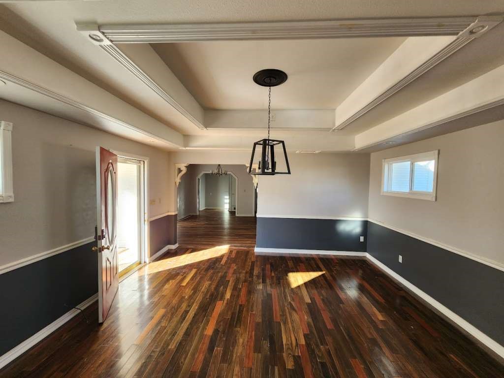 108 East 9th Street Channing, TX 79018 - Photo 7 of 16 a view of wooden floor a chandelier and window in a room