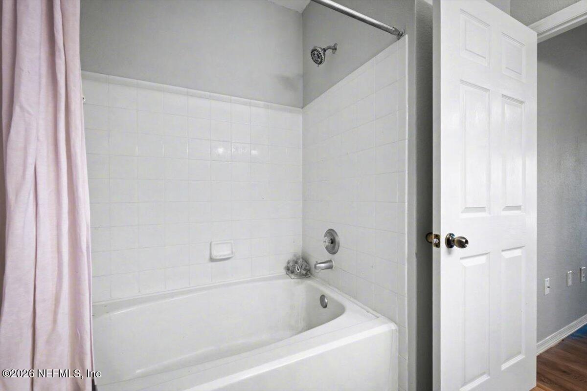 10961 Burnt Mill Road, Unit 1017 Jacksonville, FL 32256 - Photo 15 of 26 a white bath tub sitting next to a shower