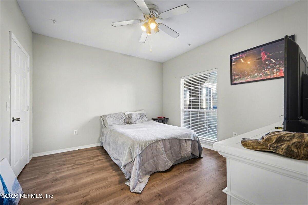 10961 Burnt Mill Road, Unit 1017 Jacksonville, FL 32256 - Photo 16 of 26 a bedroom with a bed and a chandelier