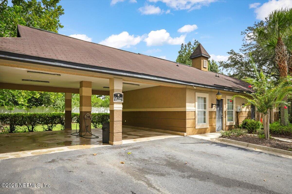 10961 Burnt Mill Road, Unit 1017 Jacksonville, FL 32256 - Photo 21 of 26 a front view of a house with a garden
