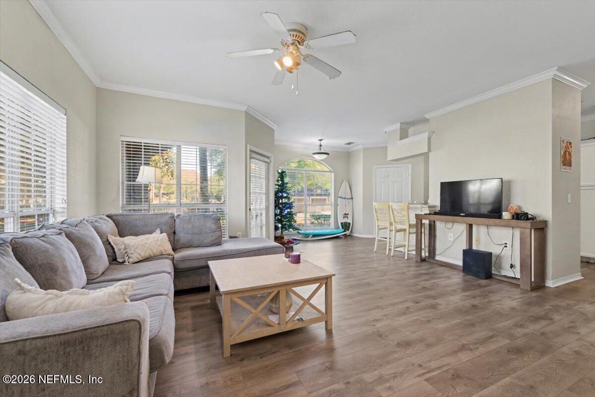 10961 Burnt Mill Road, Unit 1017 Jacksonville, FL 32256 - Photo 4 of 26 a living room with furniture and a flat screen tv