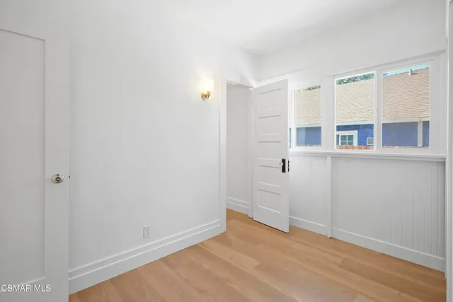 a view of a kitchen with wooden floor and windows