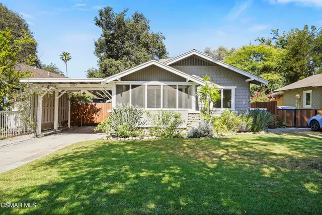 a front view of a house with a yard and porch