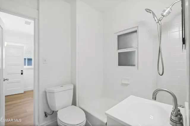 a white toilet sitting next to a bathroom sink